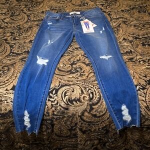 Distressed mid rise skinny ankle jean